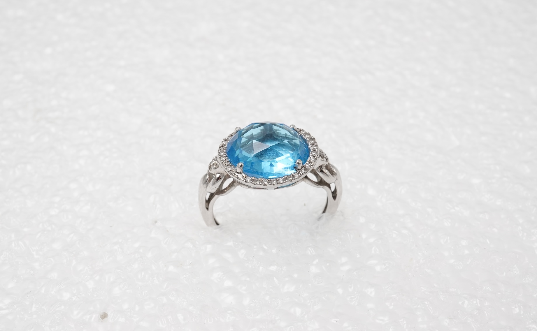 A blue topaz and diamond ring